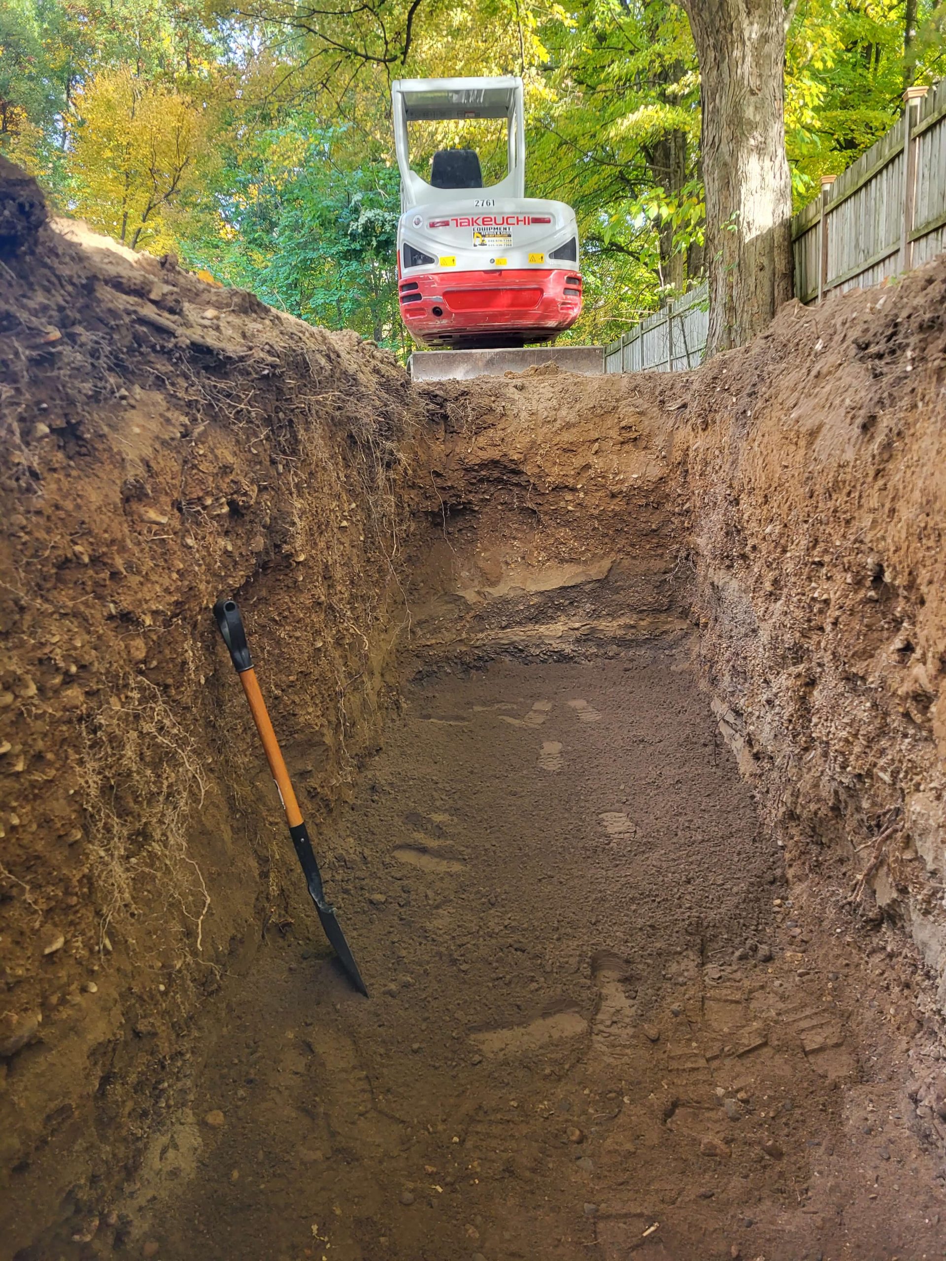 an excavator excavating trench