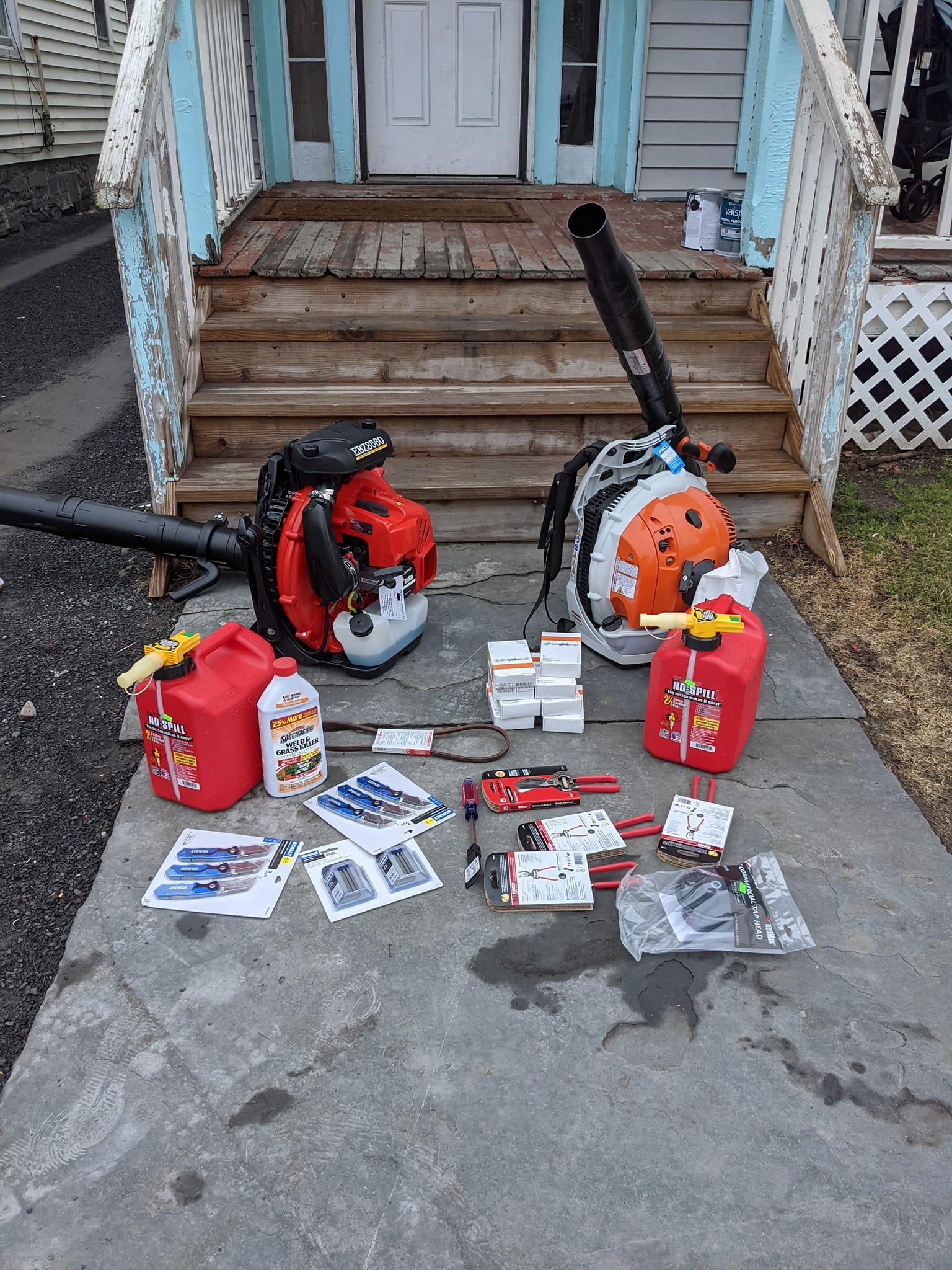 a leaf blower and chainsaw with accessories